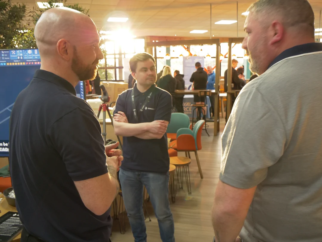 Zebraware staff stood speaking in a circle in a cafe