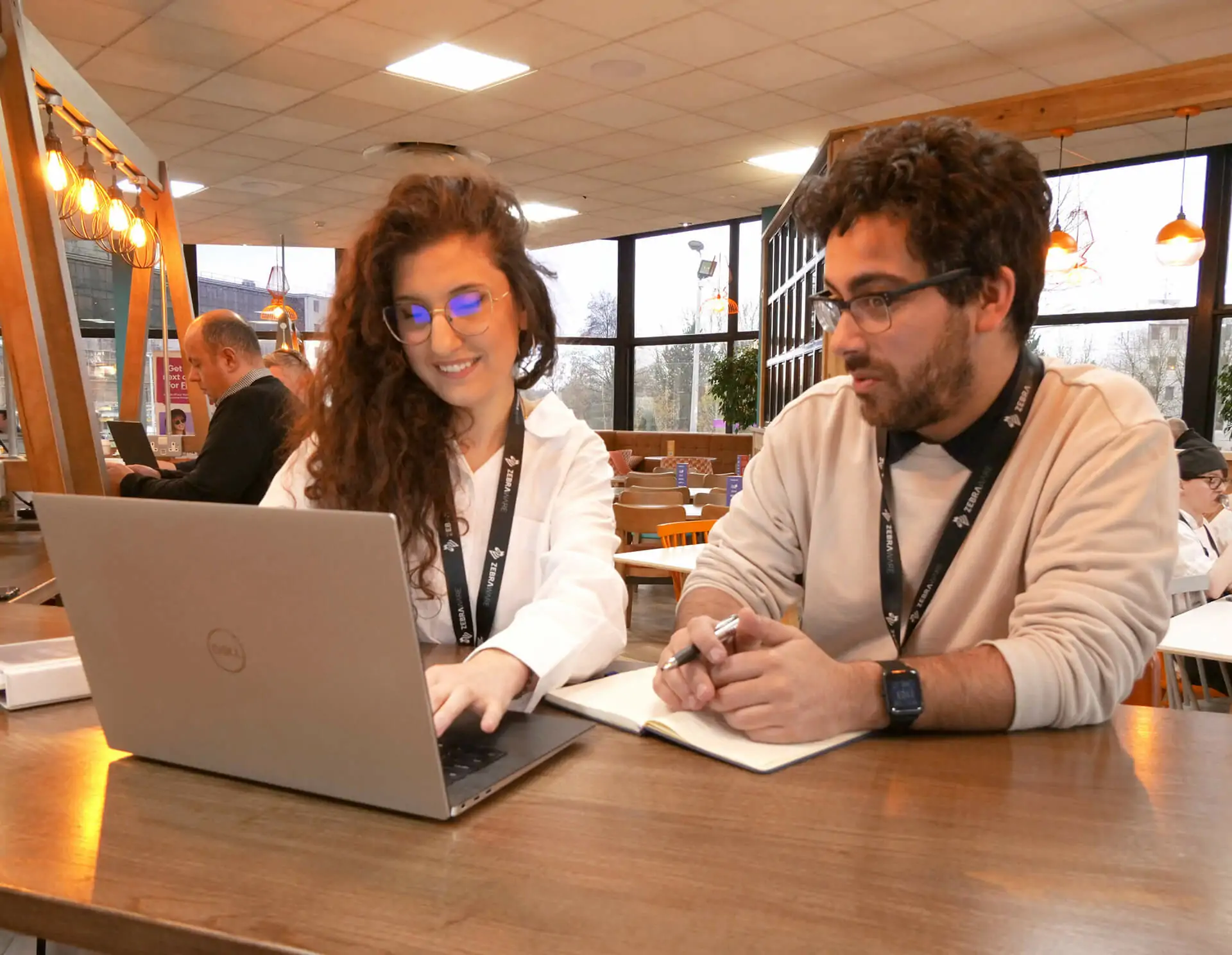 Zebraware Staff at a cafe collaborating over a laptop